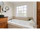 Bright bathroom featuring a luxurious soaking tub and a granite countertop at 1736 Cavendale Dr, Rock Hill, SC 29732