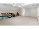 Large bonus room with carpet, white ceiling fans, lots of natural light, and ample space at 1736 Cavendale Dr, Rock Hill, SC 29732