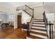 A grand foyer showcasing the staircase and hardwood floors leading to other areas of the home at 1736 Cavendale Dr, Rock Hill, SC 29732