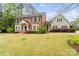 A beautiful brick home with a well-maintained lawn, complemented by lush landscaping and a connecting side house at 1736 Cavendale Dr, Rock Hill, SC 29732