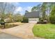Charming detached garage with a clean white door and a long driveway surrounded by landscaped lawn at 1736 Cavendale Dr, Rock Hill, SC 29732