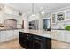 Elegant kitchen boasts a center island, white cabinetry, and designer backsplash for a sophisticated culinary space at 1736 Cavendale Dr, Rock Hill, SC 29732