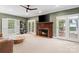 Inviting living room featuring a cozy fireplace, a ceiling fan, and French doors to the outside deck at 1736 Cavendale Dr, Rock Hill, SC 29732