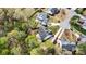 An aerial view showcases a property surrounded by lush greenery and neighboring homes at 1840 Sapona Ct, Denver, NC 28037