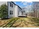 A backyard view reveals a charming deck attached to a light-colored home, surrounded by a lush lawn at 1840 Sapona Ct, Denver, NC 28037