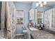 This bathroom features blue walls, white cabinets and wood-style floors at 1840 Sapona Ct, Denver, NC 28037