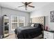The bedroom features a tufted headboard and an abundance of natural light at 1840 Sapona Ct, Denver, NC 28037