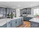 This spacious kitchen has grey cabinets and a large island with marble countertops, perfect for entertaining at 1840 Sapona Ct, Denver, NC 28037