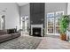Spacious living room with fireplace, large windows, and comfortable seating at 1840 Sapona Ct, Denver, NC 28037
