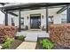 Inviting front porch with seating area and lush landscaping at 1840 Sapona Ct, Denver, NC 28037