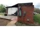 Damaged brick and painted exterior displaying a burnt facade, including electrical damage and cracked concrete at 1842 Quail Run Dr, Kingstown, NC 28150