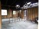 Stripped interior view of a room showcasing structural beams and window openings at 1842 Quail Run Dr, Kingstown, NC 28150