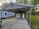Spacious carport with a concrete floor, metal beams, and a separate storage area with a roll-up door at 2021 Hilton Way Rd, Lancaster, SC 29720