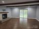 Spacious living room with a brick fireplace, hardwood floors, and a sliding glass door to the outside at 2021 Hilton Way Rd, Lancaster, SC 29720