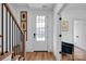 Bright entryway featuring a glass paneled door, hardwood floors, and staircase with black metal railing at 221 Davidson Gateway Dr, Davidson, NC 28036
