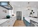 Bright kitchen featuring stainless steel appliances, white cabinets, and a modern faucet at 221 Davidson Gateway Dr, Davidson, NC 28036