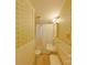 Bathroom with floral wallpaper, tiled floors, a toilet, and a sink under three lights at 224 Mcclain St, York, SC 29745