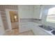 Clean kitchen with white cabinets, countertops, and a stainless steel sink at 224 Mcclain St, York, SC 29745