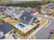 Aerial view of a home showcasing a backyard pool, patio area, and landscaped surroundings at 2332 Paddlers Cove Dr, Lake Wylie, SC 29710