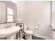 Neat half bathroom featuring a large sink, mirror, dark floors and modern fixtures at 2332 Paddlers Cove Dr, Lake Wylie, SC 29710