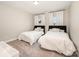 Bright bedroom with two beds, plush carpeting, and a view to the outdoors at 2332 Paddlers Cove Dr, Lake Wylie, SC 29710