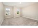 Neutral bedroom with plush carpeting, bright windows, and lots of natural light at 2332 Paddlers Cove Dr, Lake Wylie, SC 29710