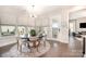 Bright dining area with a round table set, modern chandelier, and large windows providing natural light at 2332 Paddlers Cove Dr, Lake Wylie, SC 29710