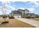 Well-maintained two-story home featuring a two-car garage and a manicured front lawn at 2332 Paddlers Cove Dr, Lake Wylie, SC 29710