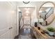 Spacious foyer featuring dark wood floors, staircase, and an ornate console table with decorative mirror at 2332 Paddlers Cove Dr, Lake Wylie, SC 29710