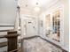 Elegant foyer with dark wood floors, staircase, chandelier, and glass-paneled doors leading to another room at 2332 Paddlers Cove Dr, Lake Wylie, SC 29710