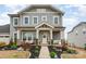 Charming home with a covered front porch, stone accents, and landscaped garden at 2332 Paddlers Cove Dr, Lake Wylie, SC 29710
