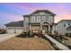Charming two-story home with a manicured front yard, three-car garage, and covered porch at 2332 Paddlers Cove Dr, Lake Wylie, SC 29710