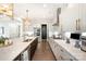 Bright kitchen featuring quartz countertops, stainless steel appliances and statement gold pendant lighting at 2332 Paddlers Cove Dr, Lake Wylie, SC 29710