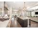 Modern, open-concept kitchen with a large island, stainless steel appliances, and pendant lighting at 2332 Paddlers Cove Dr, Lake Wylie, SC 29710