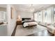 Bright bedroom with a tray ceiling, a chandelier, windows, and dark wood floors at 2332 Paddlers Cove Dr, Lake Wylie, SC 29710