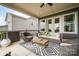 Cozy outdoor patio featuring comfortable seating, a ceiling fan, and stylish decor, perfect for relaxing or entertaining at 2332 Paddlers Cove Dr, Lake Wylie, SC 29710