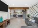 Open-concept living room featuring a cozy sitting area connected to a modern kitchen with stainless appliances at 2633 N Sharon Amity Rd, Charlotte, NC 28205