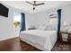 Bright main bedroom with hardwood floors, a ceiling fan, and windows offering natural light at 2633 N Sharon Amity Rd, Charlotte, NC 28205
