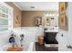 Bright bathroom featuring a tub with shower, black vanity, stylish mirror, and black and white hexagon tile floor at 2792 Lakeshore Rd, Denver, NC 28037