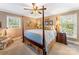 Traditional bedroom with four-poster bed, neutral walls, ceiling fan, and bright natural light from two windows at 2792 Lakeshore Rd, Denver, NC 28037