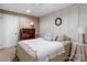 Basement bedroom featuring a bed, dresser, lamp, white walls with dark trim, and carpet flooring at 2792 Lakeshore Rd, Denver, NC 28037