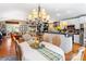 Inviting dining area open to kitchen features hardwood floors and stylish chandelier at 2792 Lakeshore Rd, Denver, NC 28037