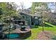A two-story green home boasts a screened-in porch, lush lawn, and backyard playground at 2792 Lakeshore Rd, Denver, NC 28037