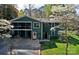 Charming two-story green home with a screened-in porch and a spacious backyard at 2792 Lakeshore Rd, Denver, NC 28037