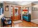 Inviting home foyer with hardwood floors, decorative woodwork, and a stylish accent bench at 2792 Lakeshore Rd, Denver, NC 28037