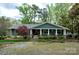 Charming single-story home featuring a welcoming front porch with stone accents and a well-maintained landscaped yard at 2792 Lakeshore Rd, Denver, NC 28037
