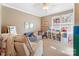 Cozy playroom featuring a comfortable armchair, small sofa, ceiling fan, and built-in shelving with toys and books at 2792 Lakeshore Rd, Denver, NC 28037