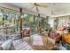 Relaxing screened-in porch with ceiling fans and views of the surrounding landscape at 2792 Lakeshore Rd, Denver, NC 28037