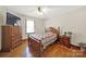Bedroom features hardwood floors, ceiling fan, and a large window at 3017 Lynwood Dr, Lancaster, SC 29720