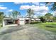 Inviting brick home with attached garage and carport, complemented by green lawn and mature trees at 3017 Lynwood Dr, Lancaster, SC 29720